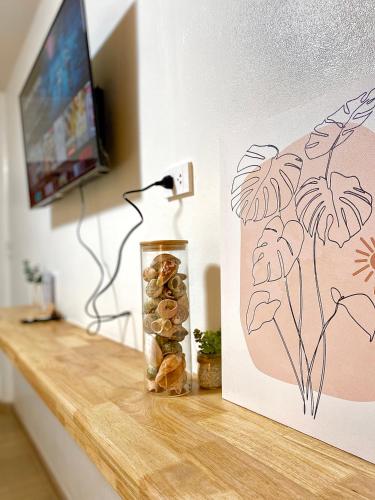 a table with a vase on it next to a painting at The O room in Ko Larn