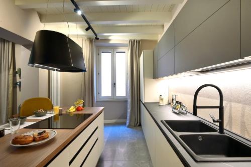 a kitchen with a sink and a counter top at Cavour 7 in Salò
