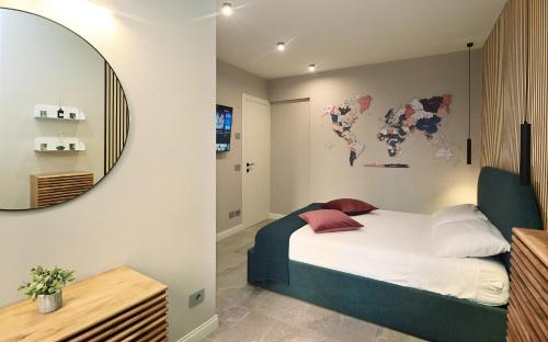 a bedroom with a bed with a mirror on the wall at Cavour 7 in Salò