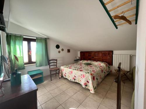 a bedroom with a bed and a table and chairs at A Casa di Amici in Tuscania
