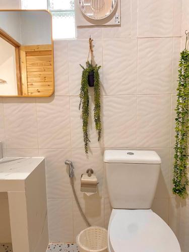 a bathroom with a white toilet and a sink at The O room in Ko Larn