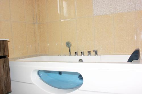 a bath tub with a blue sink in a bathroom at Fatmols Hotels in Lusaka
