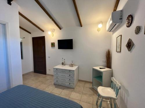 a bedroom with a bed and a desk and a tv at A Casa di Amici in Tuscania