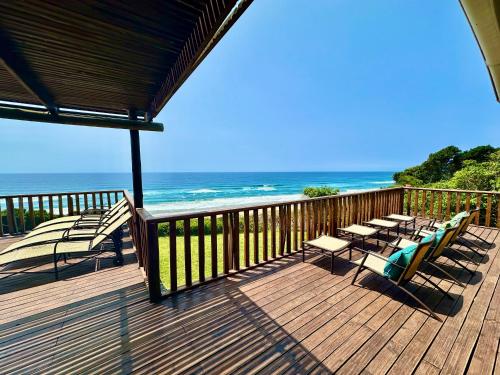 a deck with chairs and a view of the ocean at Kangela 1 in Ponta Malongane