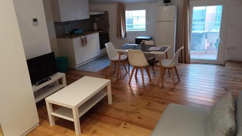 a kitchen and living room with a table and chairs at Cal 2 de Maig in Vilafranca del Penedès