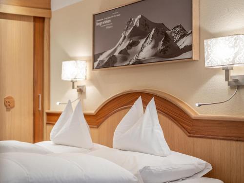 two beds with white pillows in a hotel room at Haus Annakogl und Haus Barbara in Obergurgl