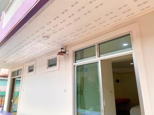 a sliding glass door on a house with a ceiling at The O room in Ko Larn