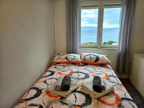 a bedroom with a bed with a window at Studio apartman Mateo in Rijeka