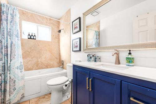 a bathroom with a toilet and a sink and a shower at Gated 6beds 2garage home near Disney other LA attraction in Chino