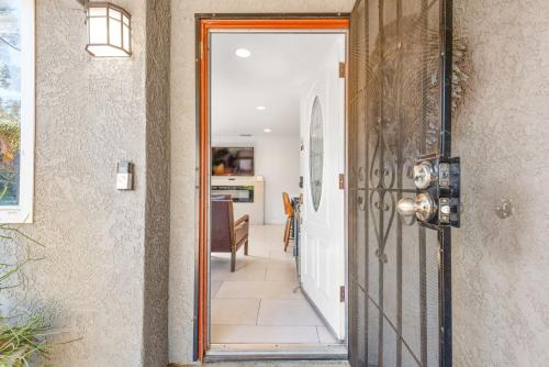 a hallway with a door leading to a dining room at Gated 6beds 2garage home near Disney other LA attraction in Chino