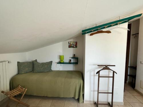 a bedroom with a bed and a ladder in a room at A Casa di Amici in Tuscania