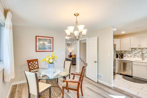 a dining room and kitchen with a table and chairs at 5 Mi to Downtown Baltimore Quiet Home with Porch in Rosedale