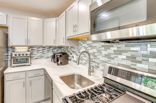a kitchen with white cabinets and a sink at 5 Mi to Downtown Baltimore Quiet Home with Porch in Rosedale