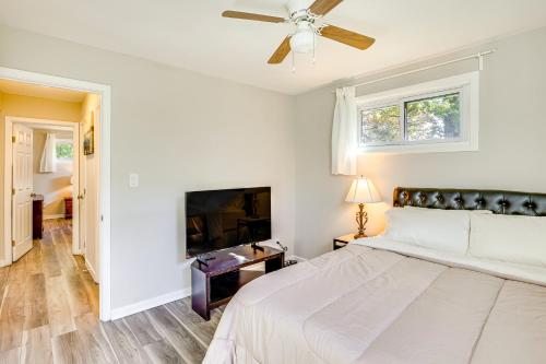 a bedroom with a bed and a ceiling fan at 5 Mi to Downtown Baltimore Quiet Home with Porch in Rosedale