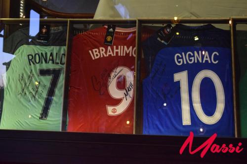 a shelf with jerseys of different teams on it at Hotel Posada Virreyes in Guadalajara