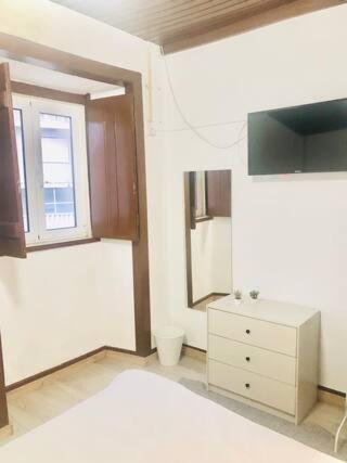 a kitchen with a sink and a cabinet and a window at Private Room 201 in Guest House da Fonte in Figueira da Foz