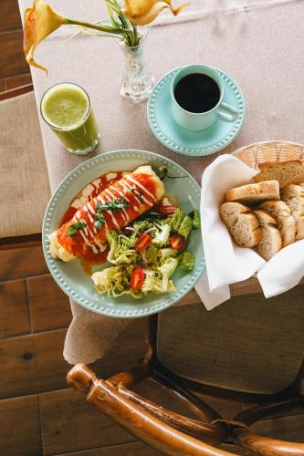 a table with a plate of food and a cup of coffee at Hotel Posada Virreyes in Guadalajara