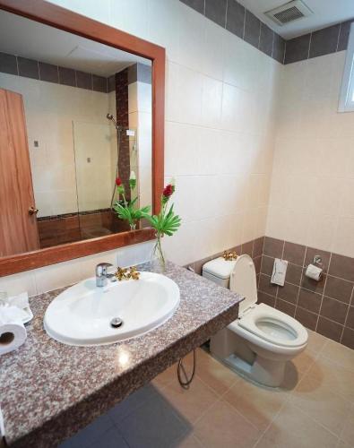 a bathroom with a sink and a toilet and a mirror at N1 House in Ao Nang Beach