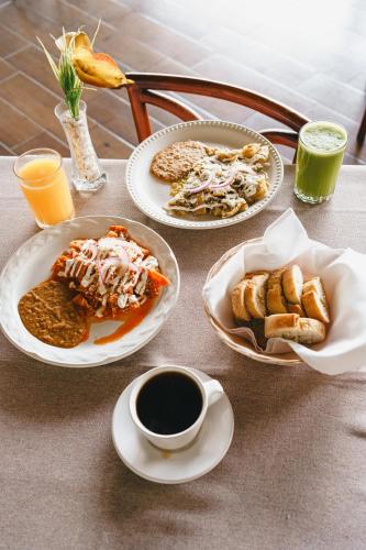 a table with plates of food and drinks on it at Hotel Posada Virreyes in Guadalajara