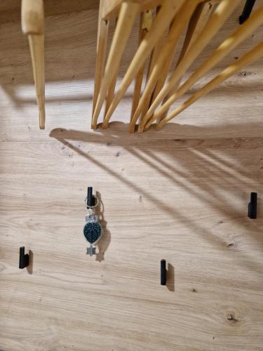 a watch on a wooden floor with wooden sticks at Cēsu Mājas Akmens ielā in Cēsis