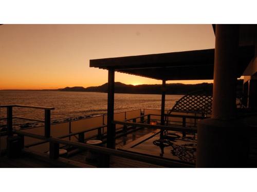 a view of the ocean from a boat at sunset at Inatori Tokai Hotel Yuen - Vacation STAY 31868v in Inatori