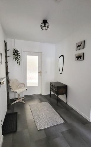 a living room with a mirror and a table at Ferienwohnung am Stadtrand in Eisenach