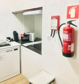 a fire hydrant is on the wall of a kitchen at Private Room 204 in Guest House da Fonte in Figueira da Foz