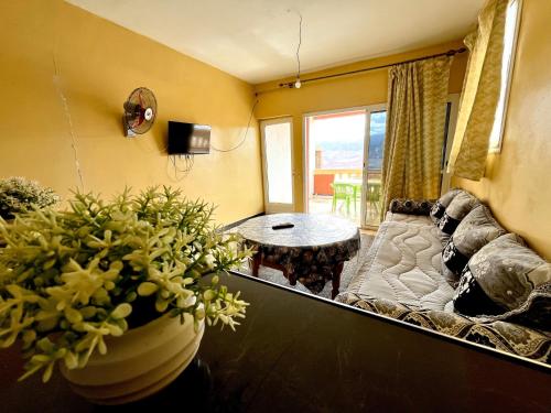 a living room with a couch and a table at Magic View in Bine el Ouidane