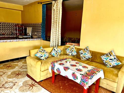 a living room with a couch and a table at Magic View in Bine el Ouidane