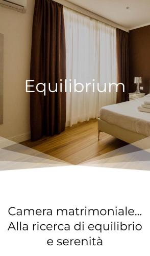 a bedroom with a bed and a window with curtains at COMÓ EXCLUSIVE in Aprilia
