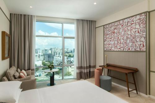 a hotel room with a bed and a large window at Hyatt Centric Santo Domingo in Santo Domingo