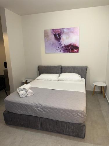 a bedroom with a bed with two towels on it at STAY-FIVE rooms & apartments in Shkodër