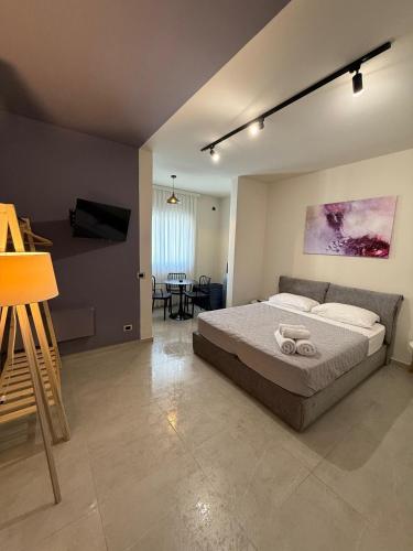 a bedroom with a bed and a living room at STAY-FIVE rooms & apartments in Shkodër