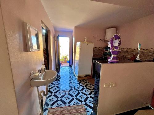 a bathroom with a sink and a refrigerator at Magic View in Bine el Ouidane