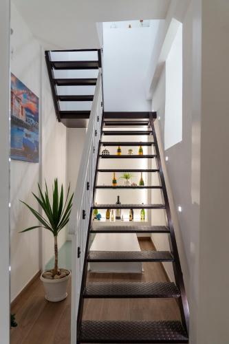 a staircase in a house with a potted plant at La Corte Guest House in Bari