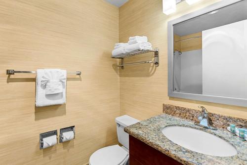 a bathroom with a sink and a toilet and a mirror at Best Western Cascadia Inn in Everett