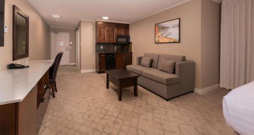 a hotel room with a bed and a couch and a table at Prestige Lakeside Resort, WorldHotels Elite in Nelson
