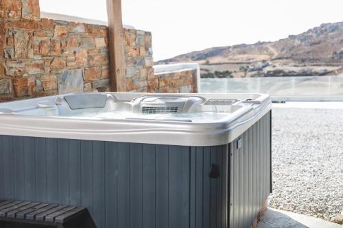 a hot tub sitting on the side of a building at Harmony Luxury Villas Naxos in Kastraki Naxou