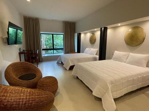Postel nebo postele na pokoji v ubytování Cuatro Lunas Hotel Boutique