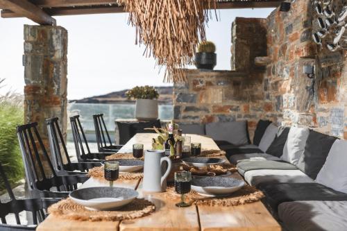 a table set for a meal with a view of the ocean at Harmony Luxury Villas Naxos in Kastraki Naxou