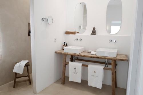 a bathroom with two sinks and a mirror at Pure House Ibiza in Ibiza Town