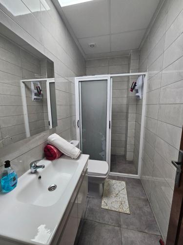 a bathroom with a sink and a shower and a toilet at Appart moderne nador al jadid près de la corniche in Nador