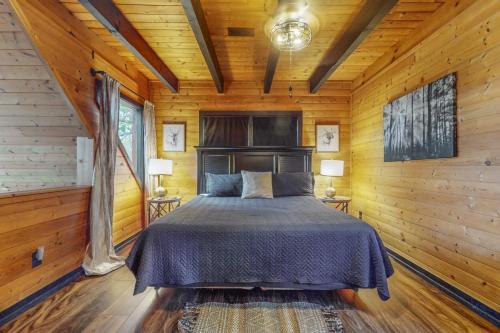 a bedroom with a bed in a wooden room at The Sweet Escape at Sky Harbor in Sevierville