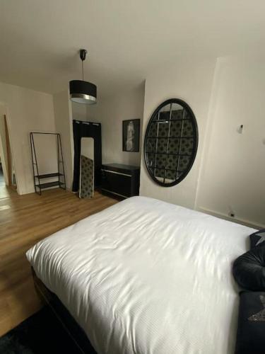 a bedroom with a white bed and a window at Apparement plein centre ville in Béthune