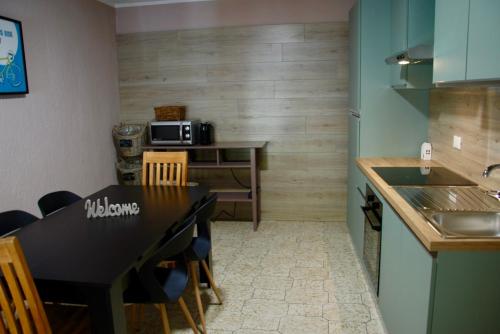 a kitchen with a black table and chairs in a kitchen at Cà Mia in Nus