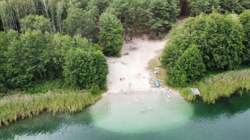 an aerial view of a river with people on a beach at Natura Domki Anastazewo in Anastazewo