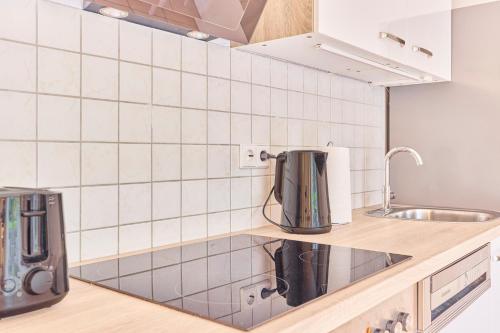 a kitchen with white tiles on the wall at Lena Ihre Ruhepause mit Terrasse in Buchen in Buchen