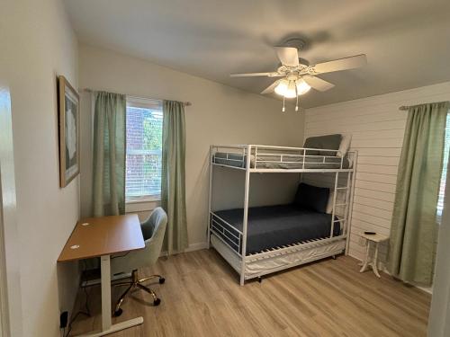 a bedroom with a bunk bed and a desk at Newly Renovated Duplex, Upper Unit, 4th row from the beach in Hilton Head Island