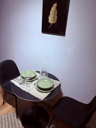 a black table with plates and glasses on it at Aman 20 in Craiova