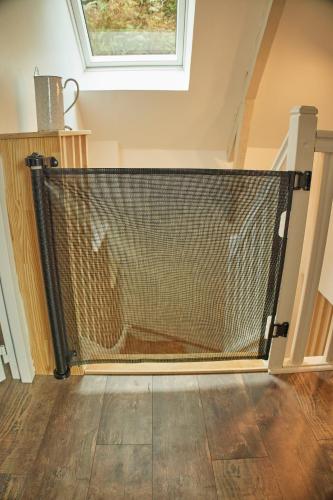 a staircase with a mesh fence in a house at Ker Adèle, longère cosy au cœur d'un bois in Ploërdut